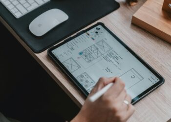 person writing on white paper