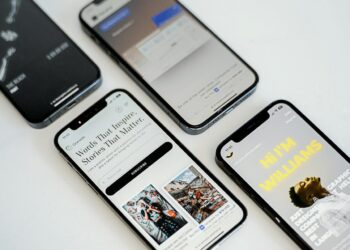 three different cell phones sitting next to each other