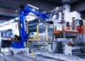 blue industrial robot arm in factory