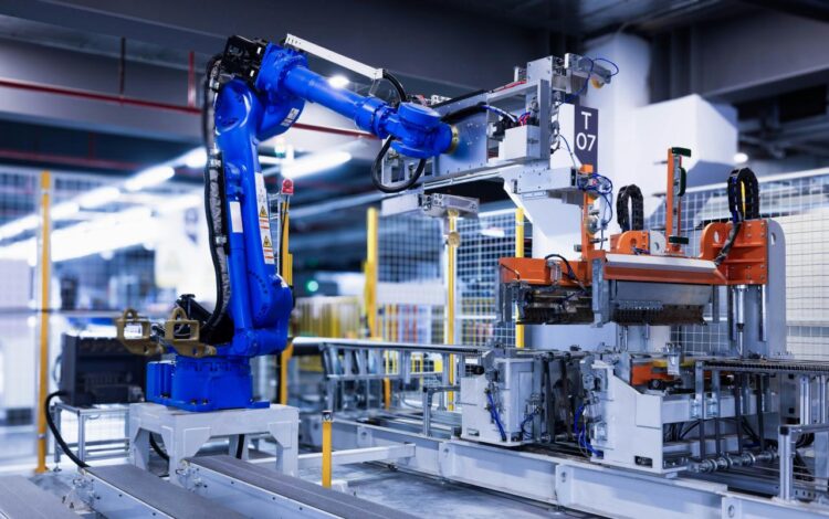 blue industrial robot arm in factory