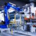 blue industrial robot arm in factory